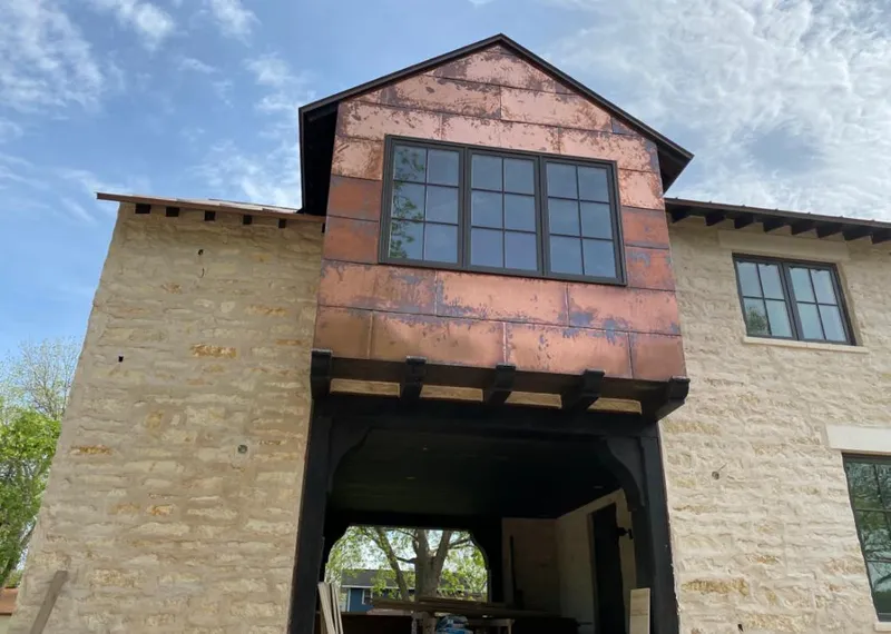 Copper metal panel facade on a stone building for Metal Roof Coating in Oakton