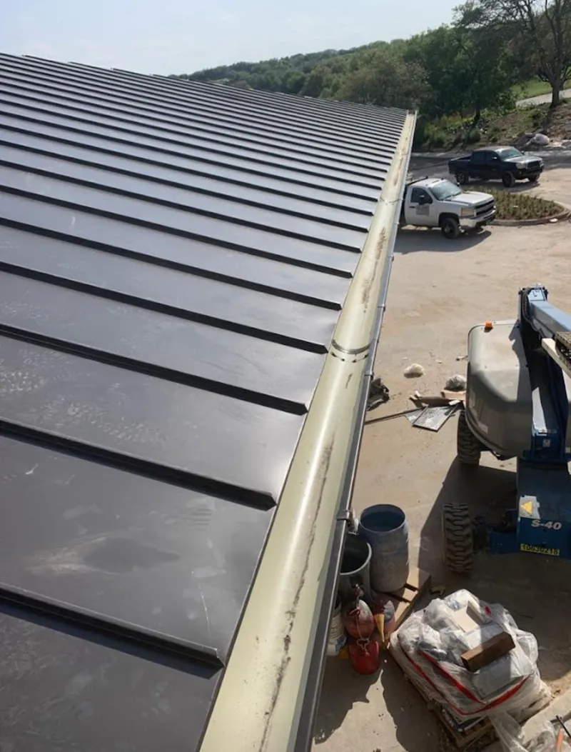 Standing seam panel and gutter detail on a metal roofing jobsite in Oakton